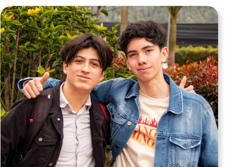 Dos estudiantes de la sede Chía posando abrazados en una zona verde del campus